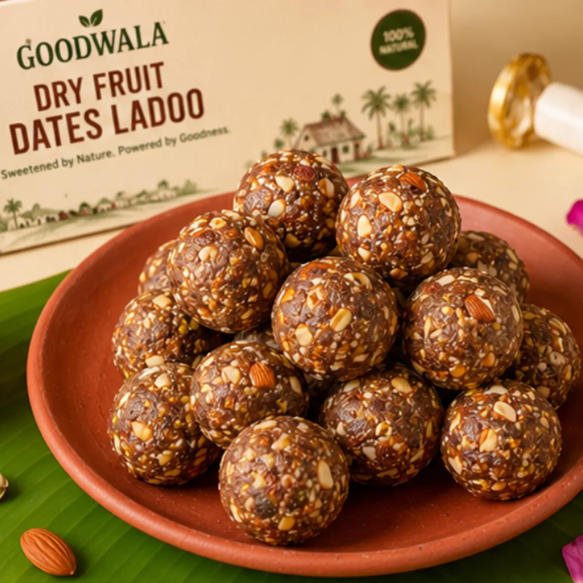 Ladoos stacked on a terracotta plate with the pack behind, on a banana leaf